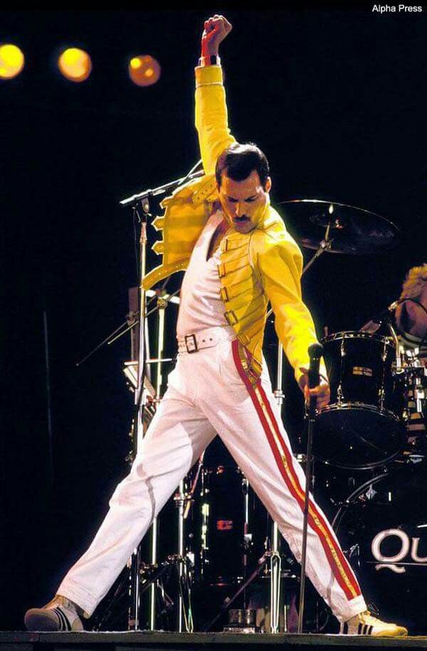 elvis presley performing on stage with his arms in the air