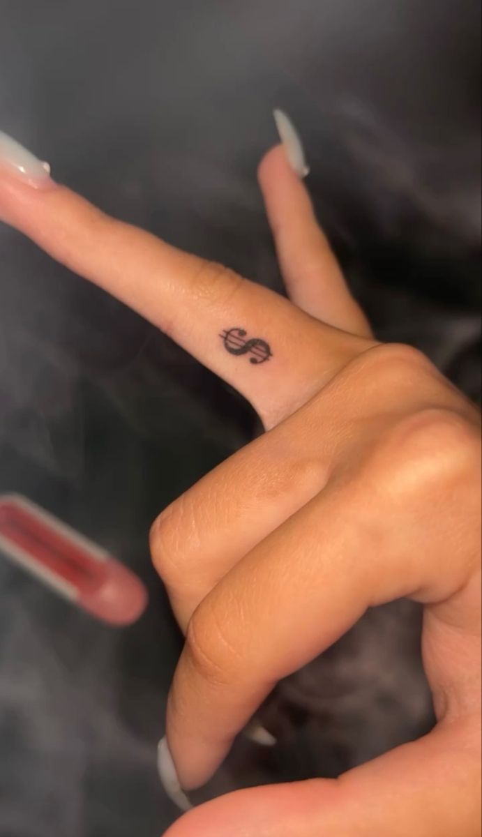 Dollar tattoo,tattoo,finger tattoo Dollar Sign Tattoo On Finger, Money Sight Tattoo, Money Sign Tattoo On Finger, Dollar Sign Finger Tattoo, Coin Size Tattoo, Red Dollar Sign Tattoo, Small Hand Tats For Women, Tattoos To Hide From Parents, Hot Small Tattoos