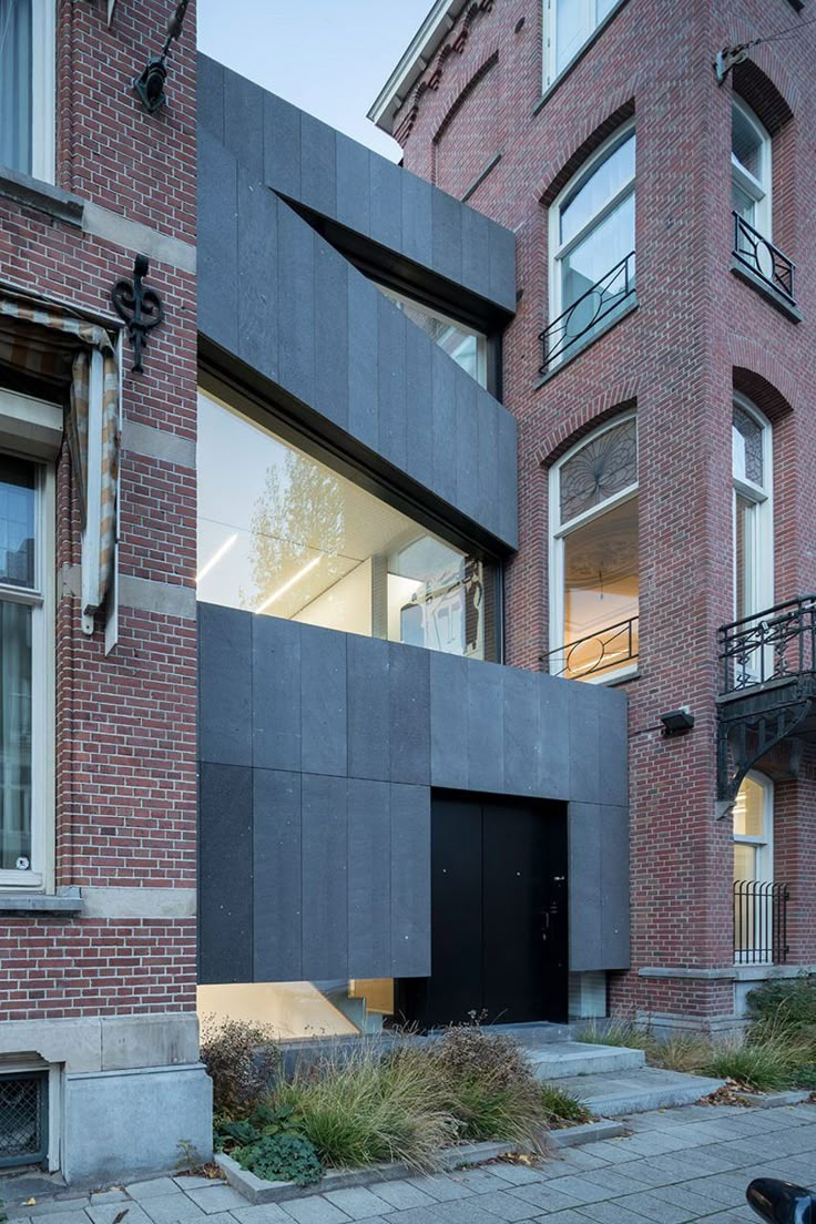 an apartment building with black doors and windows