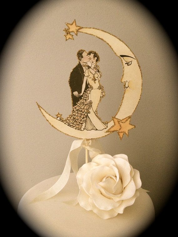 a wedding cake with a bride and groom on the moon