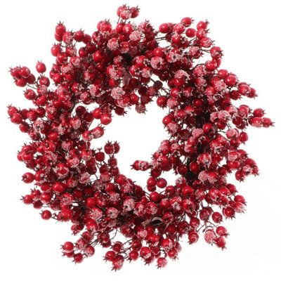 a wreath with red berries hanging from it