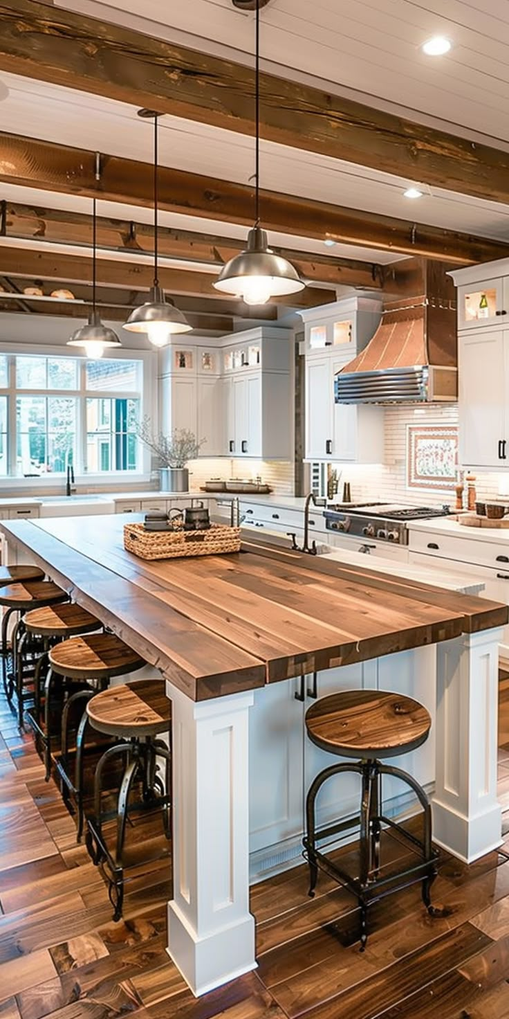 a large kitchen with an island in the middle of it and lots of stools