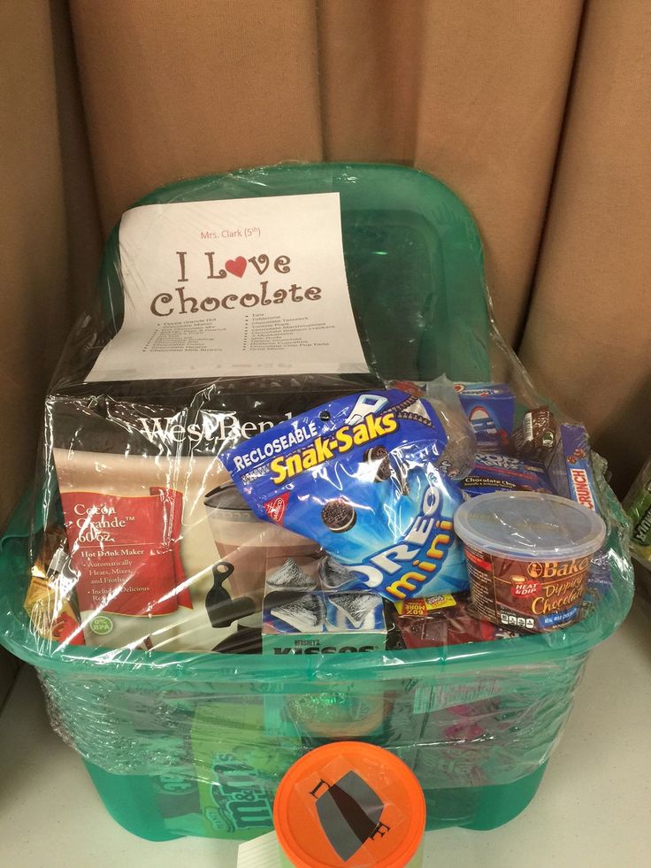 a green plastic basket filled with snacks and condiments on top of a table