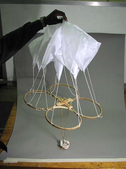 a person is holding something in front of the camera with ropes and paper on it