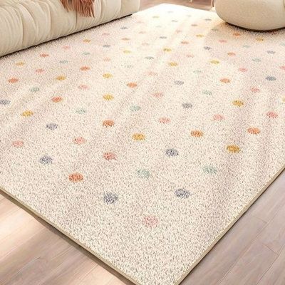 a white rug with multicolored polka dots on it in a living room setting