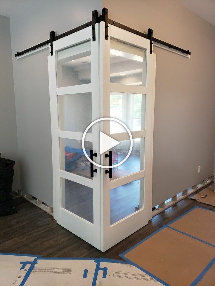 an image of a sliding door being installed in a room with blue tape on the floor