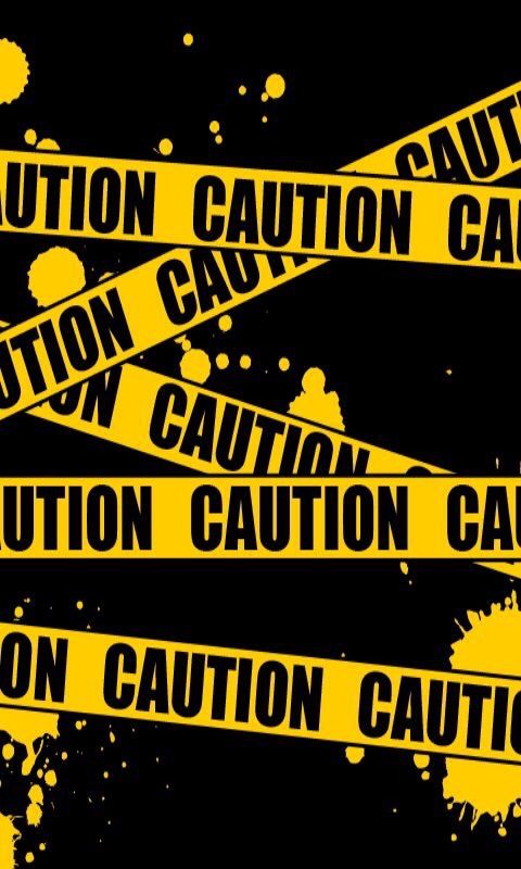 yellow caution tape with black ink splatters on it and the words caution caution cause