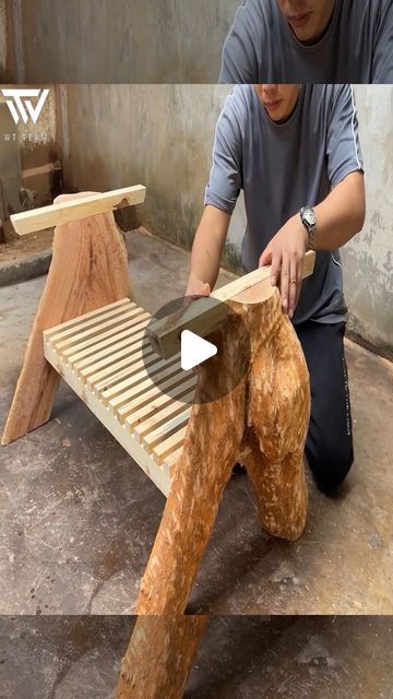 a man working on a bench made out of wood