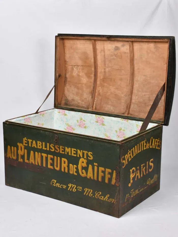 an old wooden box with the lid open and floral fabric lining on it's sides