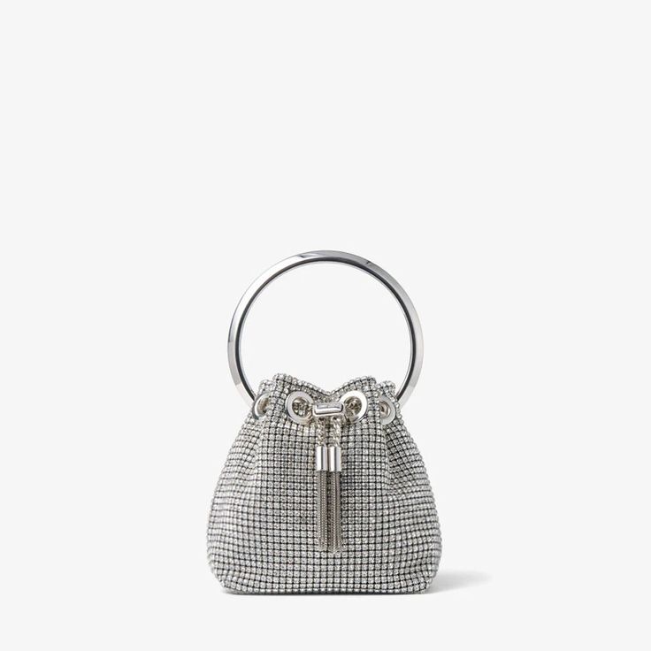 Our signature Bon Bon handbag is crafted in silver crystal mesh. A statement accessory to love forever, it is finished with a sparkling crystal top handle and a sleek drawstring chain that cinches the supple shape. Designed with chain strap for versatile styling. Monogrammed Cuff, Crystal Top, Bridal Bag, Luxury Belts, Evening Handbag, Bon Bon, Silver Crystal, Mesh Bag, Sparkling Crystal