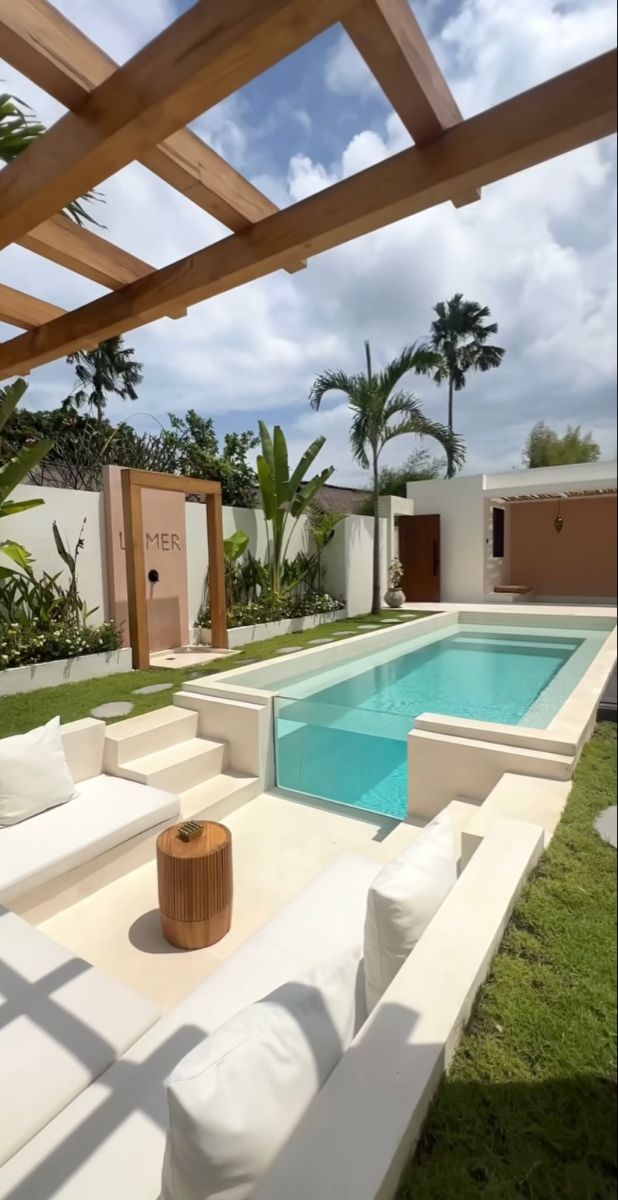 an outdoor living area with a pool and patio furniture