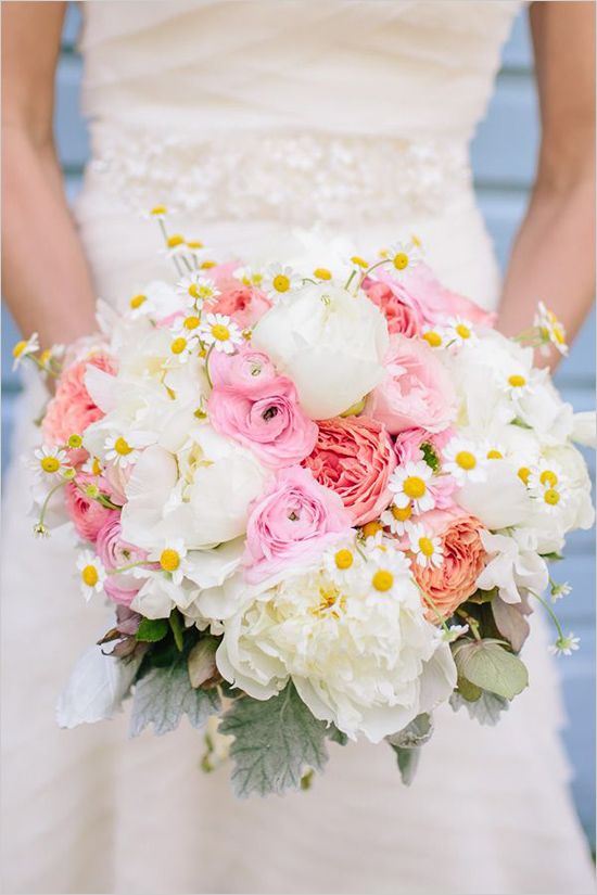 a bridal holding a bouquet of white and pink flowers