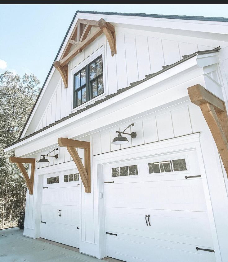 two white garages with wood trim and windows