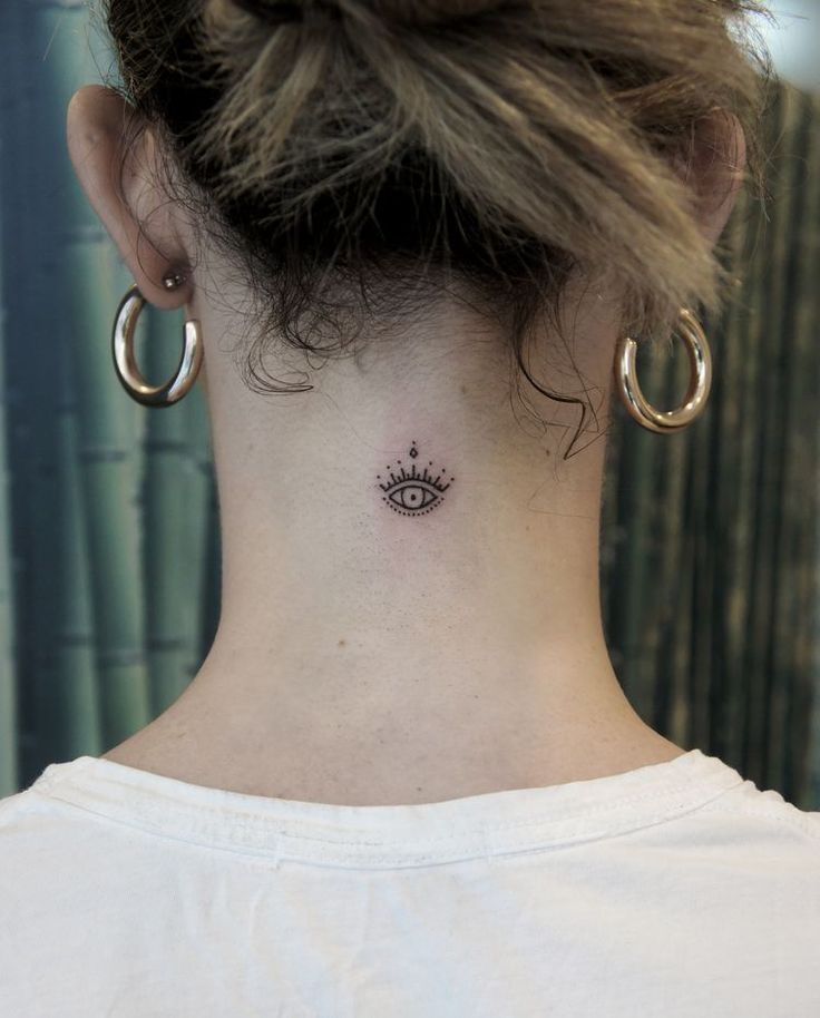 a woman with a small tattoo on her neck