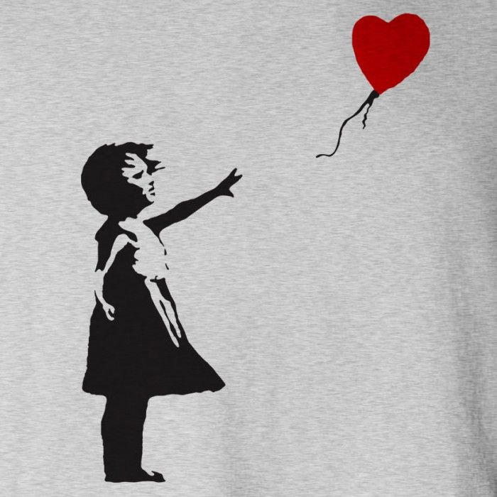 a girl holding a red balloon with a heart on it's string, in front of a white t - shirt that says i love you