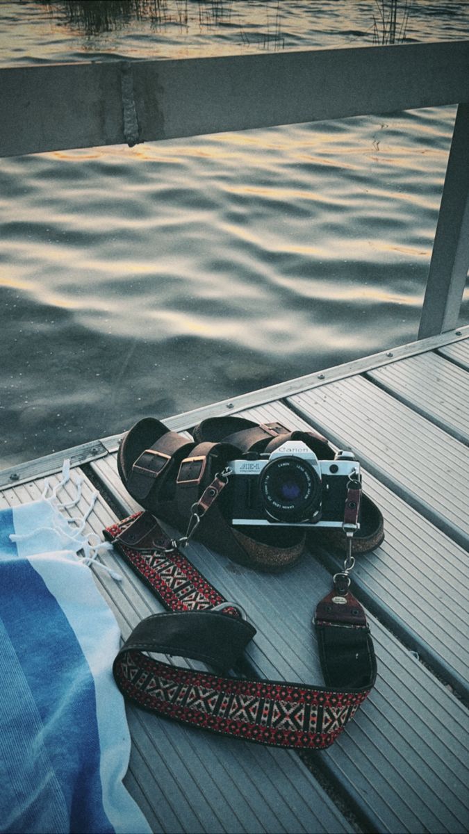 a camera and some shoes on a dock