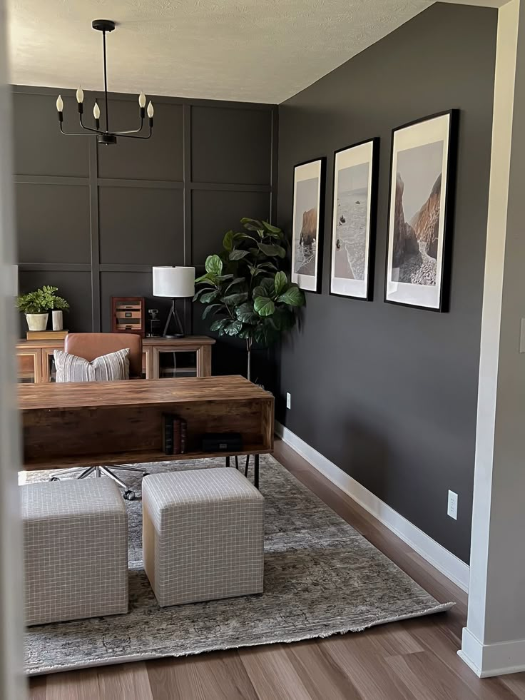 a living room with grey walls and white furniture in the corner, along with pictures on the wall