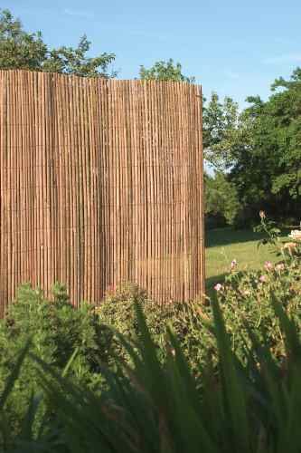 a wooden fence in the middle of a grassy area