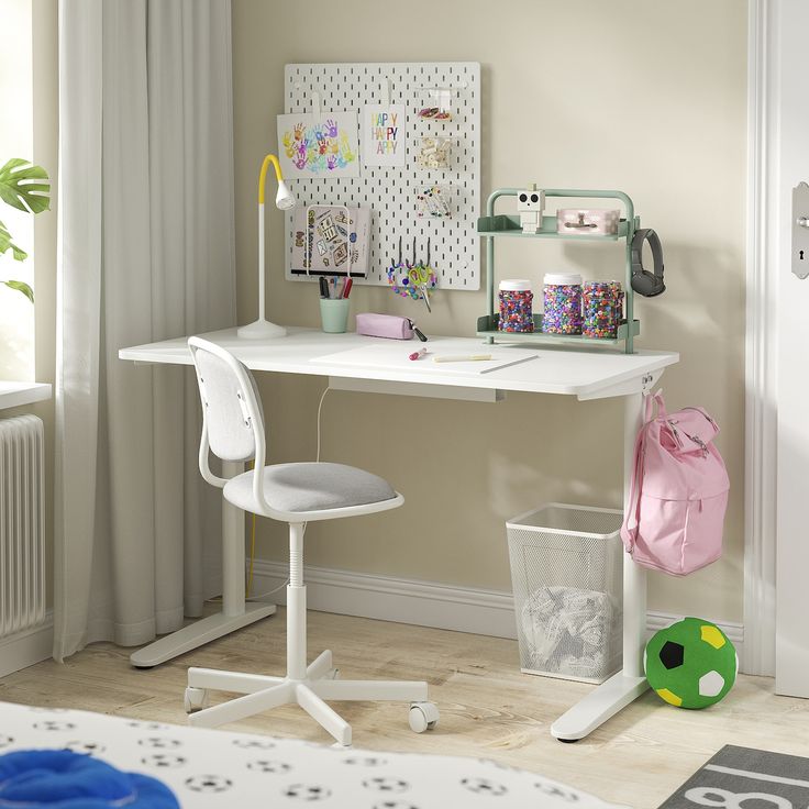 a white desk and chair in a room with a wall mounted pegboard on the wall