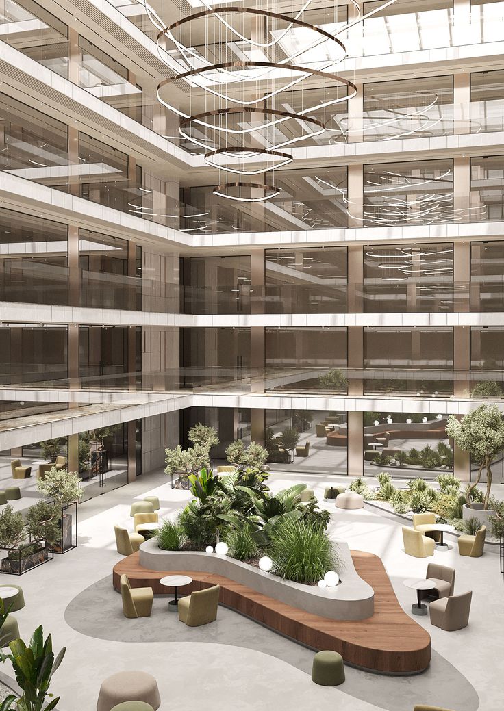 the interior of an office building with lots of plants and benches in front of it