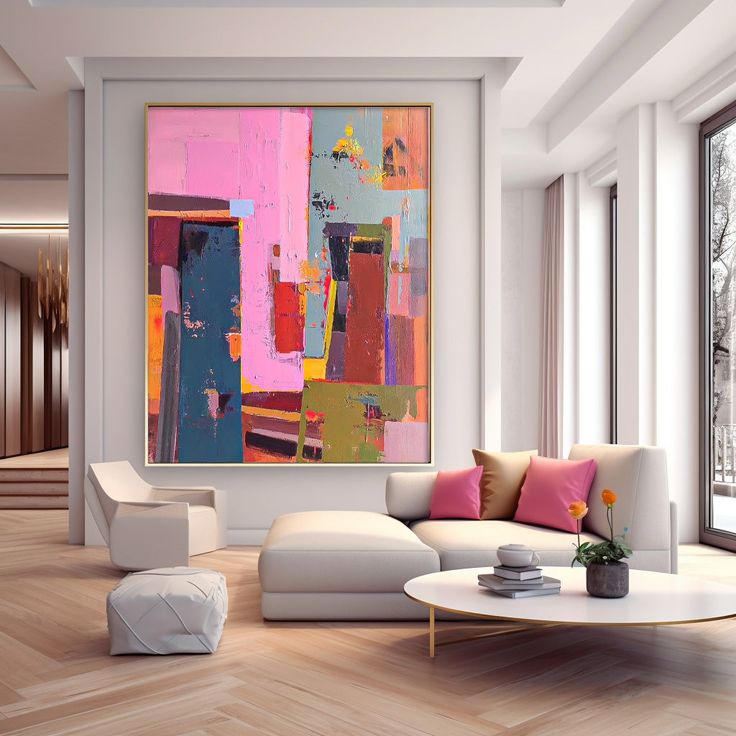 a living room filled with white furniture and large paintings hanging on the wall above them