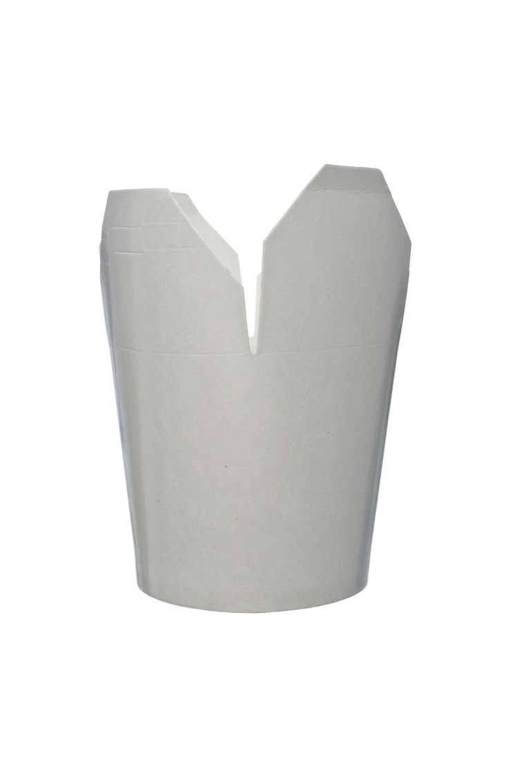 a white vase sitting on top of a table