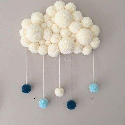 a white cloud with blue balls hanging from it's sides