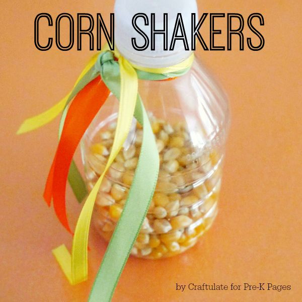 corn shakers in a glass jar with ribbon around the top on an orange table