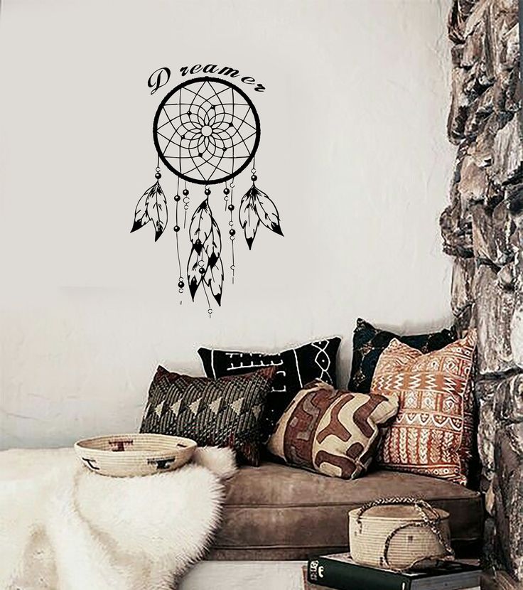 a living room filled with furniture and a dream catcher wall decal on the wall