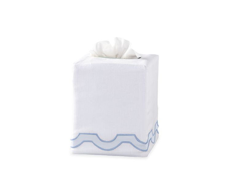 a white tissue box with blue waves on the front and bottom, sitting on a white surface