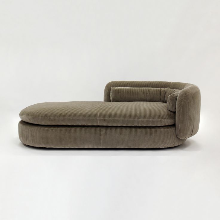 a grey couch sitting on top of a white floor