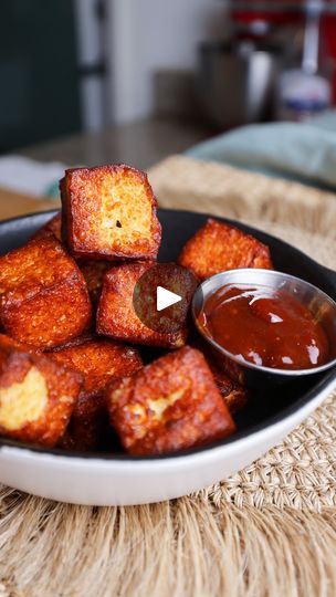 a plate full of tofu cubes with dipping sauce