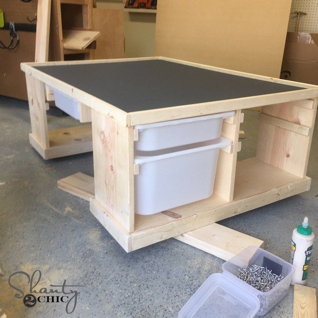 an unfinished workbench with tools and supplies on the floor