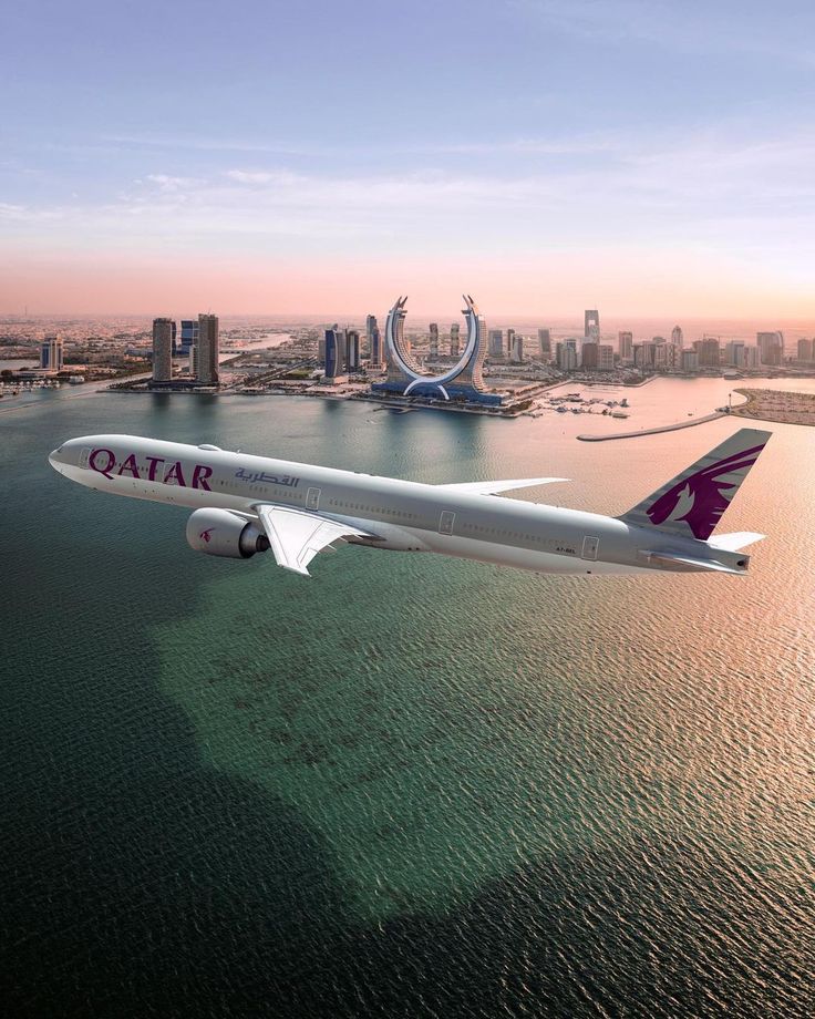 an airplane is flying over the water in front of a city