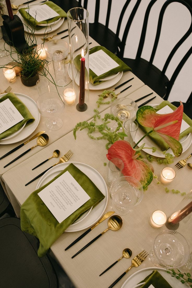 the table is set with place settings for dinner