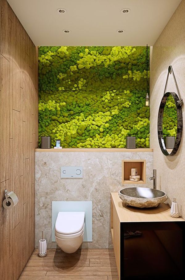 a bathroom with a toilet, sink and green wallpaper on the walls in it