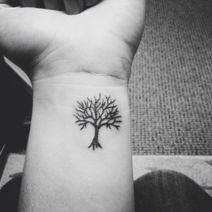 a small tree on the wrist is shown in this black and white photo, it looks like someone has been inked