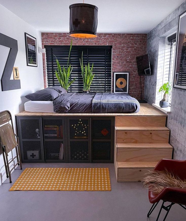 a bed sitting on top of a wooden shelf next to a window filled with plants