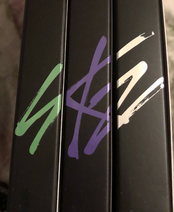 three black and purple skis with different designs on them