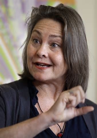 a woman in black shirt pointing at something