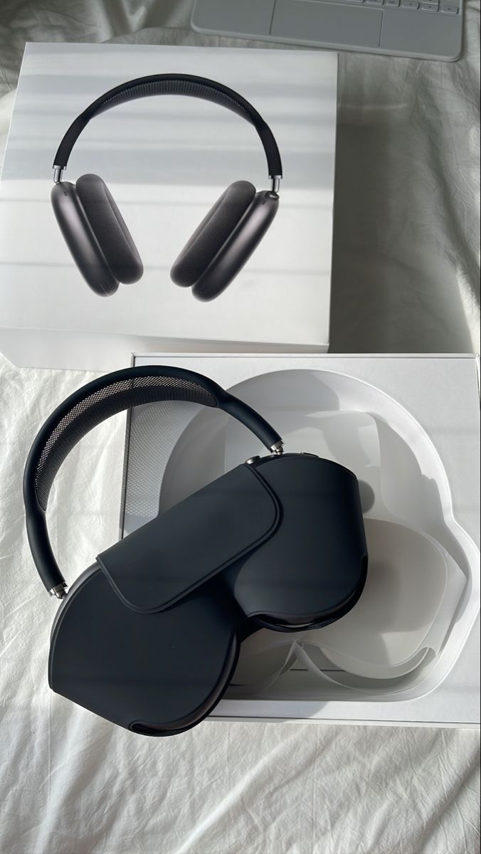 two black headphones sitting on top of a white box