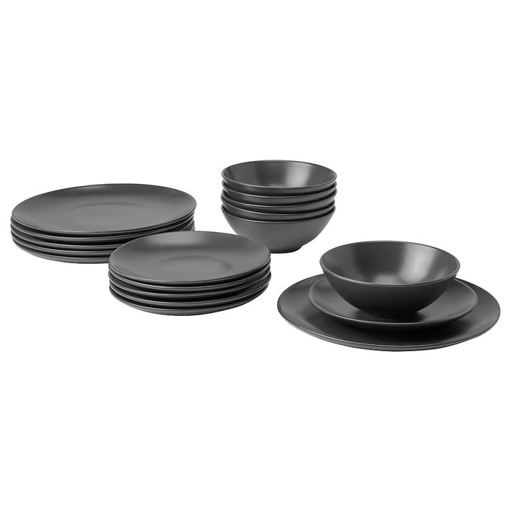 a set of black dinnerware on a white background