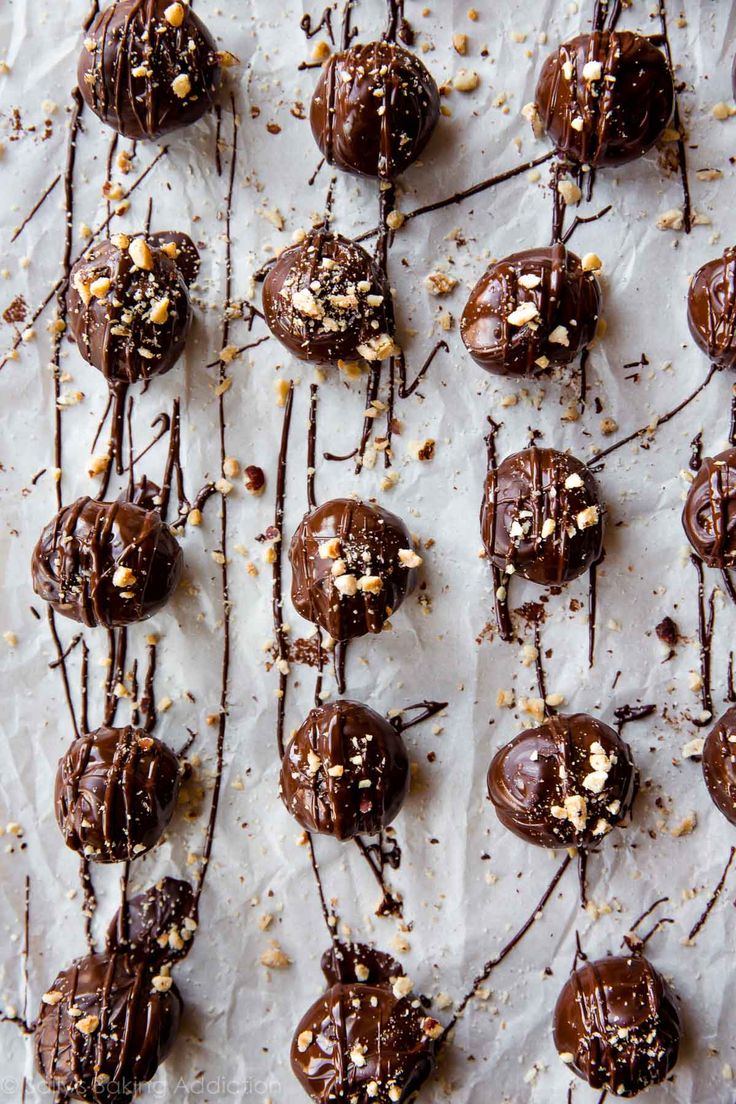 chocolate covered donuts are arranged on a sheet of paper