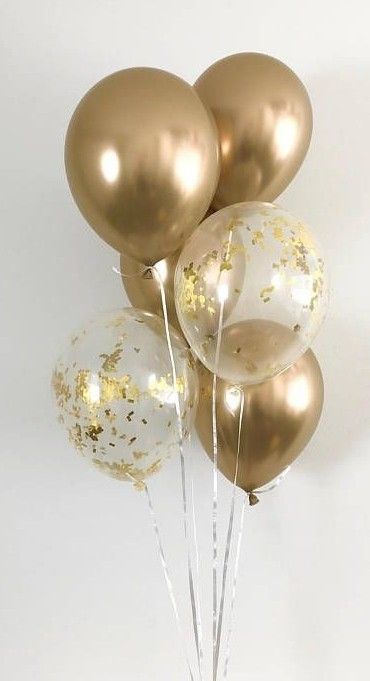 gold and white balloons with confetti on them