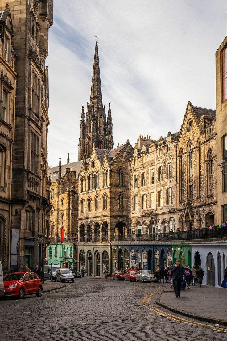 an old city street with cars parked on the side