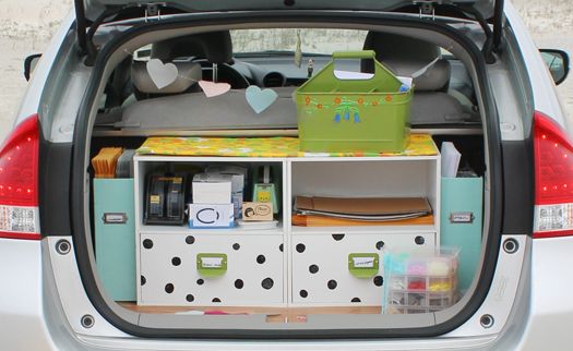 the back end of a car with its trunk open and various items on display in it