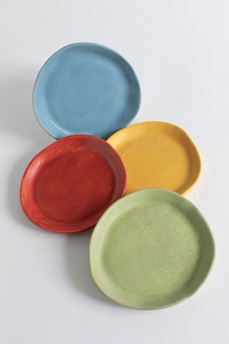 three different colored plates sitting next to each other