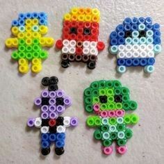 four different types of beaded toys on a table