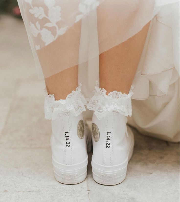 a close up of a person wearing white shoes