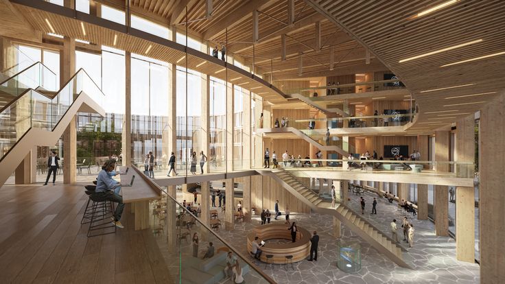 the inside of a large building with lots of windows and people walking around it on wooden floors